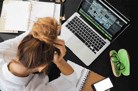 woman looking at laptop in frustration