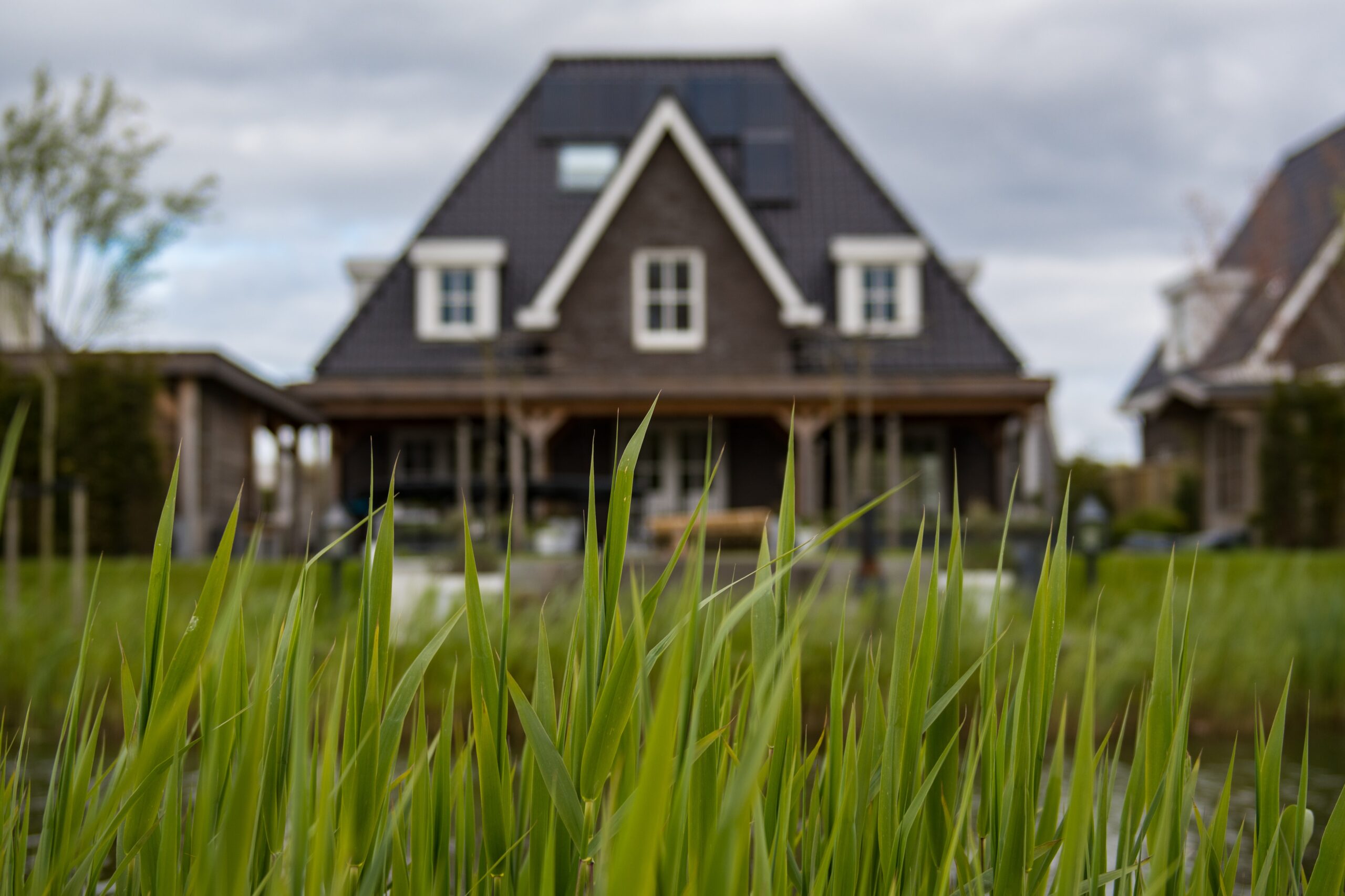 Ground view of home in background in front of grass